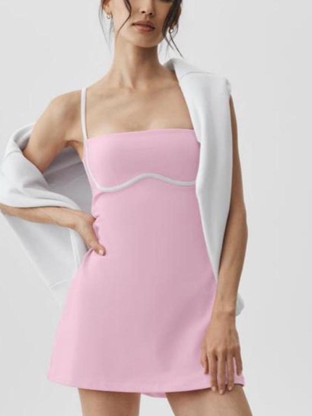 ALO Yoga Airbrush Streamlined Mini Dress in Pink Marshmallow with White Trim.